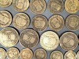 several different types of coins are arranged in a circle on a table