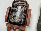 a small wooden object with a black and white design on it