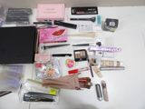 a lot of makeup and makeup products on the table