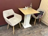 two chairs and a table in the corner of a room