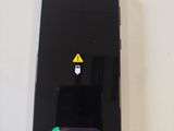 a close up of a cell phone with a sticker on it