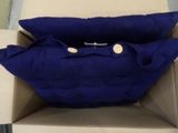 two blue pillows in a box on a table
