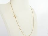 a white mannequin torso with a gold chain necklace on it