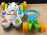 a toy car and a toy cow on a table