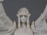 a statue of a woman holding a cell phone in her hand