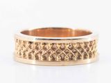 an image of a gold ring with a pattern on it