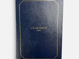 a black book with gold trim and a gold logo on the cover