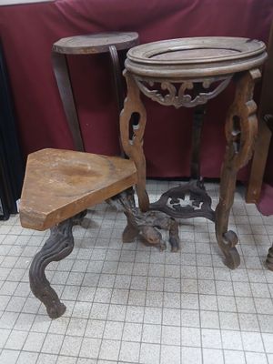 a small table and two stools in the corner of a room