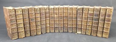 the old books are lined up in a row on the table