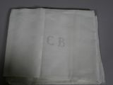 a close up of a napkin with a monogram on it