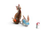 two figurines of a cat and a rabbit sitting next to each other