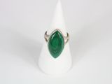 a close up of a ring with a green stone on it
