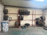 many tires on the shelves in the garage