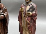 two figurines of a man and a woman dressed in medieval clothing