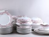 a lot of plates and bowls on the table