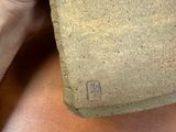 a person holding a piece of clay in their hand