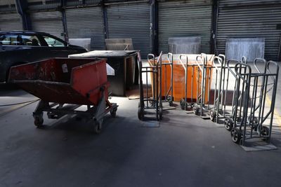 many carts that are lined up in a garage