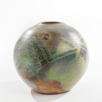 a vase with a green and brown design on it