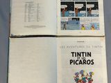 two pages of a comic book open on a table