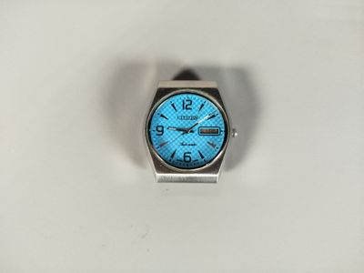a watch that is sitting on a white surface