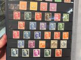 a person holding a book with a lot of stamps on it