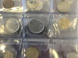 a lot of coins that are in a clear box