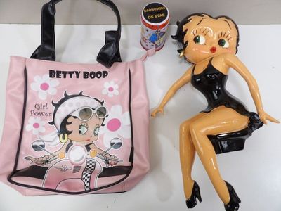 a plastic doll sitting next to a plastic bag