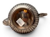 an image of a silver plate with a tag on it