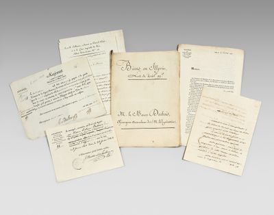 several old papers with writing on them sitting next to each other