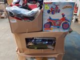 boxes of toys are stacked on top of a cart in a warehouse