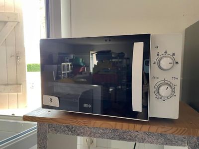 a microwave sitting on top of a counter in a kitchen