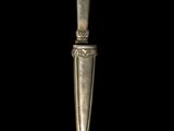an old silver spoon on a black background with a black background