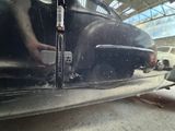 a man working on a car in a garage