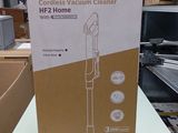 packaging for a cordless vacuum cleaner on a table in a store