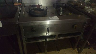 a stove top with a frying pan on it in a kitchen