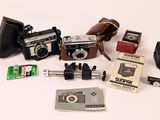 many different types of cameras on a white surface