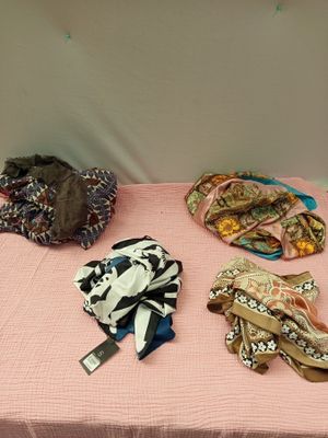 de nombreux types de chapeaux et d'écharpes posés sur une table