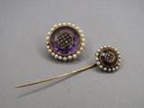 two purple and white pearls and a gold broocher