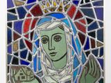 stained glass of the virgin of guadalupe with a crown on her head
