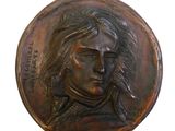 a bronze plaque of a man with a pipe in his mouth