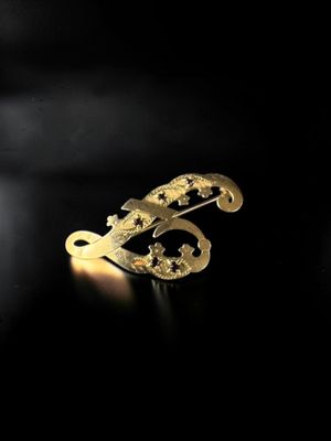 an image of a close up of a gold ring on a black surface