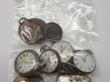 a bag of assorted pocket watches on a table