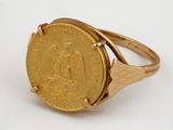 an image of a gold ring with a coin on it