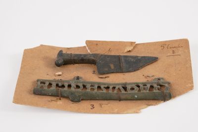a knife and a knife holder on a piece of paper
