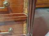 a wooden desk with two drawers and a mirror on it