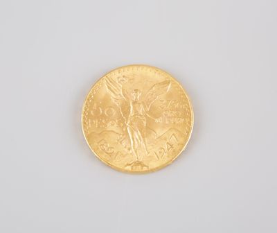 a close up of a gold coin on a white surface