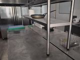 a kitchen with stainless steel counter tops and stainless steel shelves