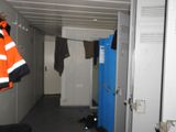 a hallway with a bunch of clothes hanging on the clothes rack