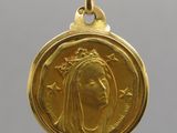 a close up of a gold coin with a woman ' s face on it