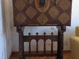 a small table with a wooden top and a chair in front of it